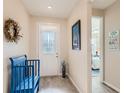 Inviting foyer showcasing a decorative door, wood-look floors, and a charming blue bench at 2812 Ruby Rose Ln, St Cloud, FL 34771