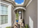 Inviting front entrance featuring a covered porch with stylish decorations and a welcoming doormat at 2812 Ruby Rose Ln, St Cloud, FL 34771