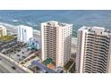 Aerial perspective showcasing oceanfront building and parking at 3311 S Atlantic Ave # 1402, Daytona Beach, FL 32118