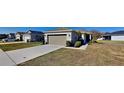 Exterior of house with driveway, lawn, and two-car garage at 4601 Glencrest Loop, Saint Cloud, FL 34772