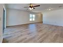 Open living area with light walls, vinyl flooring, and a ceiling fan at 4601 Glencrest Loop, Saint Cloud, FL 34772