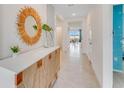 Bright and airy entryway with decorative mirror and console table at 5087 Tana Ter, Saint Cloud, FL 34772