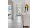 Light-filled entryway with white console table and mirror at 5087 Tana Ter, Saint Cloud, FL 34772