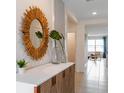 Bright and airy entryway with decorative mirror and console table at 5087 Tana Ter, Saint Cloud, FL 34772