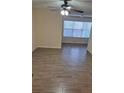 Bright living room features wood-look tile floors at 5112 Conroy Rd # 13, Orlando, FL 32811