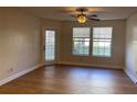 Living room with wood-look flooring, sliding glass door, and ceiling fan at 6106 Westgate Dr # 103, Orlando, FL 32835