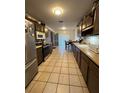 Long kitchen with ample cabinet space and appliances at 6133 Olympic Ct, Orlando, FL 32808