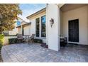 Charming front patio with sitting area and brick pavers at 6228 Lecco Way, Windermere, FL 34786