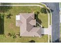Overhead view of a home with a well-maintained roof, green lawn, and surrounding neighborhood at 707 Terranova Ave, Winter Haven, FL 33884