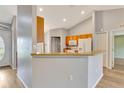 Bright kitchen area with a breakfast bar, white appliances, and light wood cabinets at 707 Terranova Ave, Winter Haven, FL 33884
