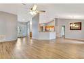 Open living room featuring vaulted ceilings, wood-look flooring, and a ceiling fan at 707 Terranova Ave, Winter Haven, FL 33884
