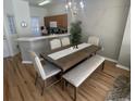 Dining room features wood flooring, a large table, and bench seating at 8513 Crystal Cove Loop, Kissimmee, FL 34747