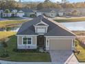 Single-Gathering home aerial view, showcasing a backyard pond and neighborhood at 8575 Hempstead Way, Mount Dora, FL 32757