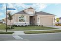 House exterior view with street sign and landscaped front yard at 8575 Hempstead Way, Mount Dora, FL 32757