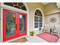 Elegant red double doors entry with sidelights at 971 Worthington Ct, Oviedo, FL 32765