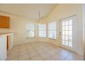 Breakfast nook with tile floor, window seat and door to backyard at 108 Strait Dr, Davenport, FL 33897