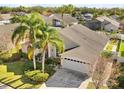 Aerial view of single Gathering home with two palm trees in front at 11016 Orangeshire Ct, Ocoee, FL 34761