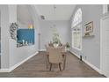 Bright dining room features a chandelier and large window at 11016 Orangeshire Ct, Ocoee, FL 34761