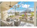 Relaxing screened patio with seating area, ceiling fan, and view of backyard at 11016 Orangeshire Ct, Ocoee, FL 34761