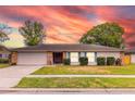 Single-story home with a brick facade, attached garage, and landscaped lawn at 116 Sheridan Ave, Longwood, FL 32750