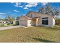 Two-story house with a double-car garage and a small front yard at 1448 Brook Hollow Dr, Orlando, FL 32824