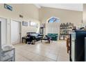 Living room with high ceilings, tiled floors, and a large window at 1448 Brook Hollow Dr, Orlando, FL 32824