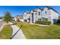 Two-story house with gray exterior, landscaping, and a two-car garage at 1713 Fullers Oak Loop, Winter Garden, FL 34787