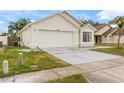 Front view of a one-story house with a two-car garage at 1820 Putney Cir, Orlando, FL 32837