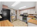 View of kitchen with stainless steel appliances and light wood cabinets at 2010 Brookside Dr, Mount Dora, FL 32757