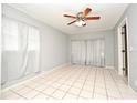 Bright bedroom with tile flooring, ceiling fan, and neutral-colored walls at 2090 Ashland Blvd, Orlando, FL 32808