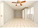 Spacious bedroom with tile flooring, ceiling fan, and neutral walls at 2090 Ashland Blvd, Orlando, FL 32808