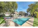 Inviting rectangular pool with patio and tropical landscaping at 2100 Suffield Dr, Winter Park, FL 32792