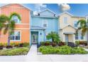 Colorful two-story townhome featuring a landscaped front yard and inviting entry at 2904 On The Rocks Pt, Kissimmee, FL 34747