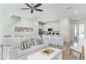 Bright living room with white couch and kitchen view at 2904 On The Rocks Pt, Kissimmee, FL 34747