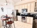 Bright kitchen with stainless steel appliances and an eat-in area at 303 Palmview Ct, Kissimmee, FL 34743