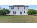 Rear view of the house, showing a large grassy backyard at 3170 Santa Cruz Dr, Kissimmee, FL 34746