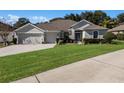 One-story home with a two-car garage, neatly landscaped yard at 381 Skyview Pl, Chuluota, FL 32766