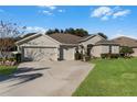 Single-story house with two-car garage and well-maintained lawn at 381 Skyview Pl, Chuluota, FL 32766