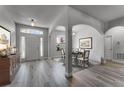 Welcoming foyer features a dining area, light gray wood flooring, and an abundance of natural light, setting an inviting tone at 381 Skyview Pl, Chuluota, FL 32766