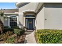 Inviting front entry with a navy blue door and landscaping at 381 Skyview Pl, Chuluota, FL 32766