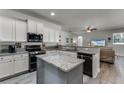 Modern kitchen with stainless steel appliances and an island at 381 Skyview Pl, Chuluota, FL 32766