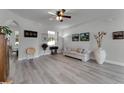 Bright living room with hardwood floors, a sofa, and large windows at 381 Skyview Pl, Chuluota, FL 32766