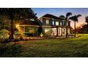 Stunning two-story home with manicured landscaping and a well-lit facade at 3943 W Campbell Rd, Lakeland, FL 33810