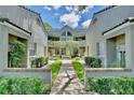 Neat courtyard entry to a two-story condo building with lush landscaping at 3992 Radley Ct, Longwood, FL 32779