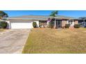 Front view of a brick house with a garage and lawn at 425 Iowa Woods E Cir, Orlando, FL 32824