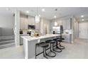 Modern kitchen with gray cabinets, large island, and stainless steel appliances at 4418 Small Creek Rd, Kissimmee, FL 34744