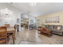 Bright dining room with a chandelier and views to the living room at 4705 Pershoie Ln, Kissimmee, FL 34746