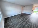 Spacious living room with wood-look floors at 5325 Curry Ford Rd # 101, Orlando, FL 32812