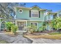 Front view of a charming two-story house with green siding at 5978 Braemar Pl # 108, Orlando, FL 32822