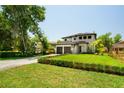 Landscaped front yard featuring a manicured lawn and a lovely two-story home with large driveway at 6564 Lagoon St, Windermere, FL 34786